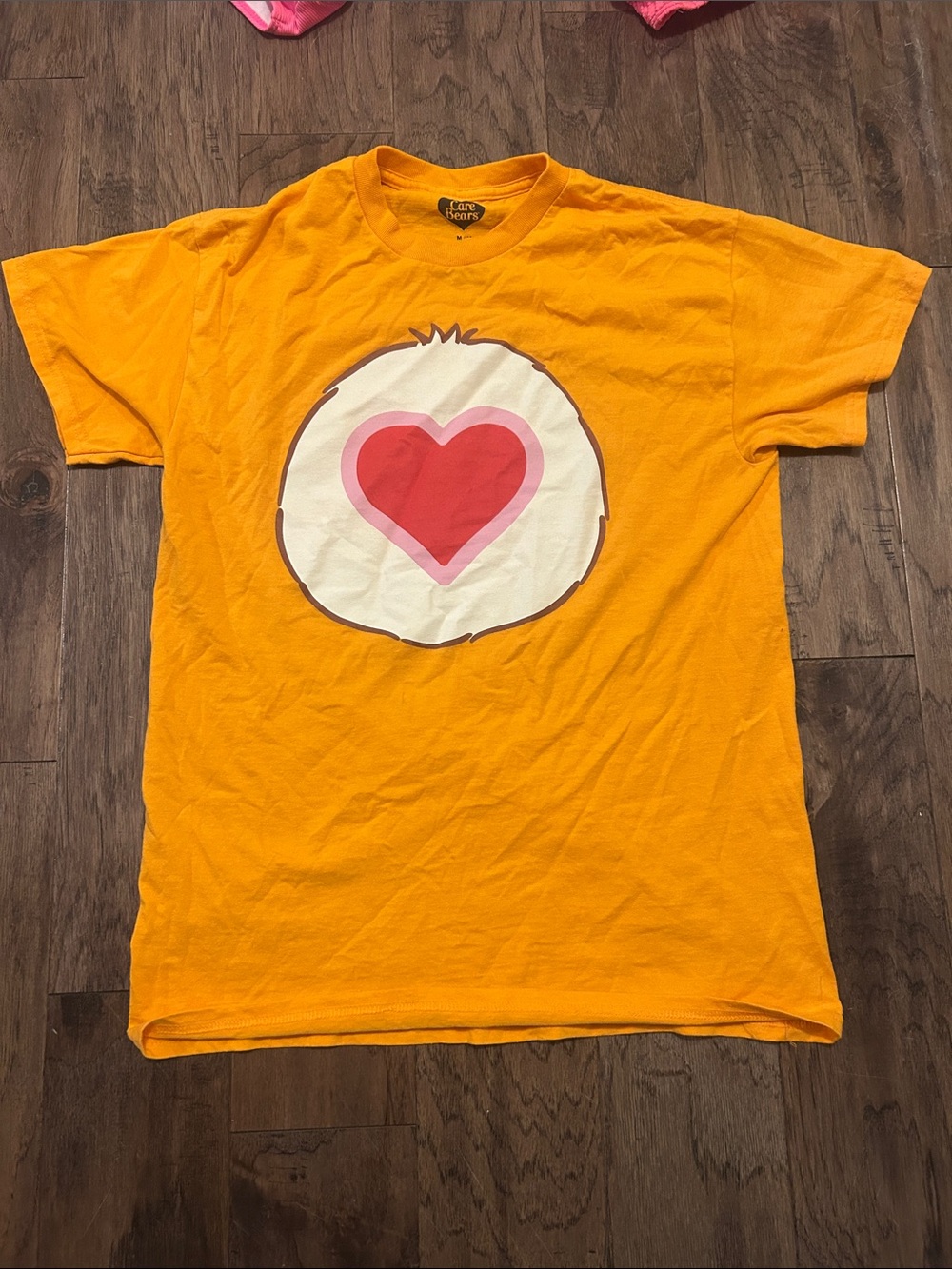 Care Bears Yellow Orange Short Sleeve Tee with Heart Badge